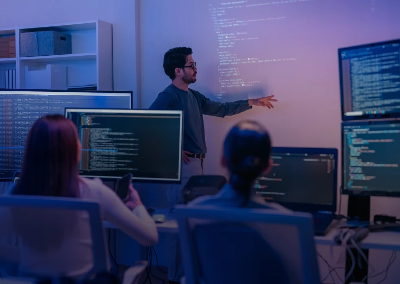 Office meeting with multiple screens