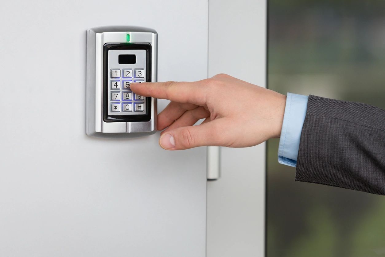 Person using a keypad access control system at an entrance