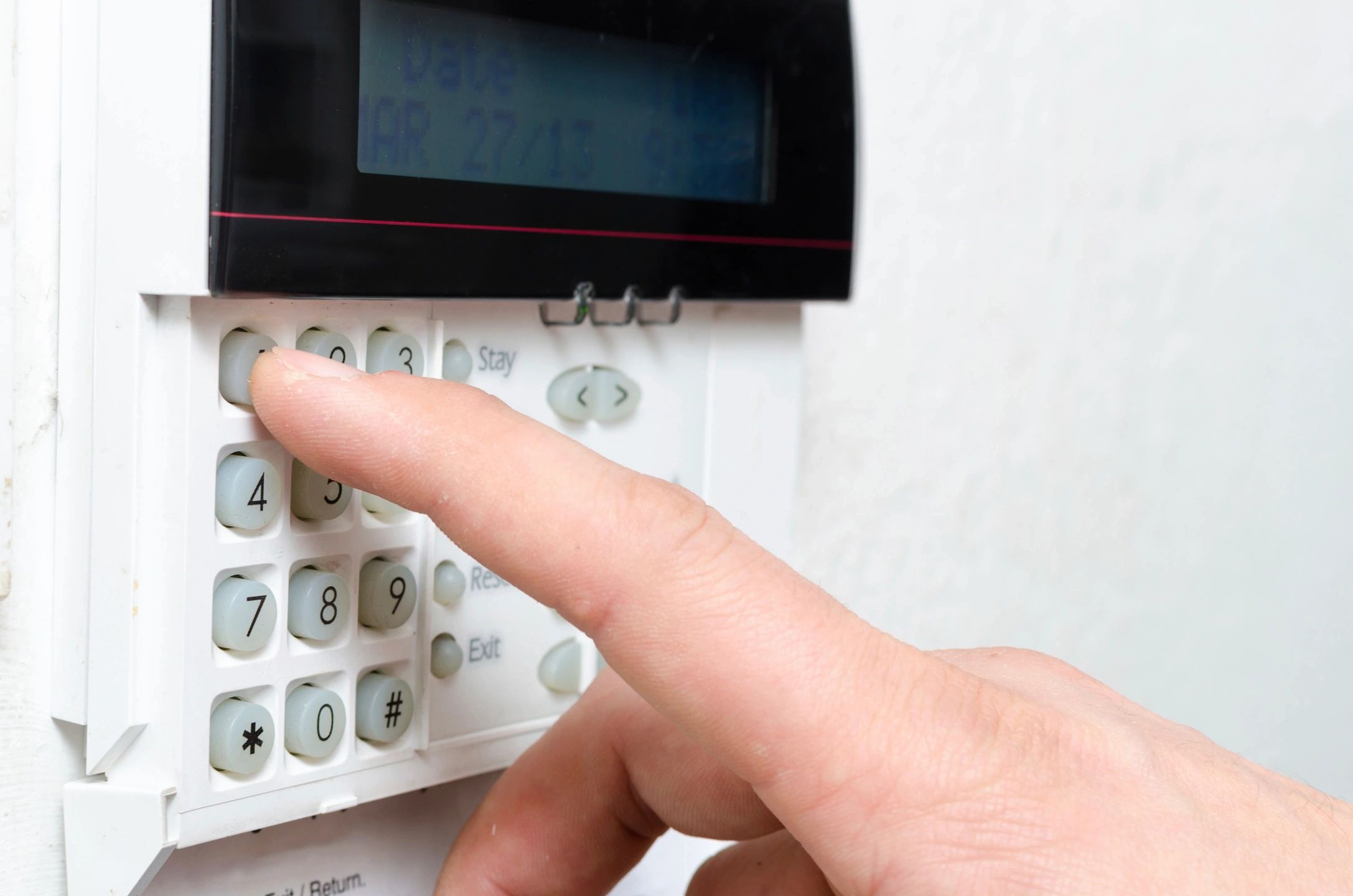 Person operating a security alarm control panel